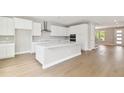 Bright kitchen with large island, stainless hood vent, and modern cabinetry at 4017 W North B St, Tampa, FL 33607