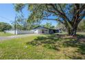 Spacious, shaded backyard featuring a well-maintained lawn and privacy fence at 4814 Knights Loop, Plant City, FL 33565