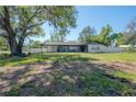 Lawn view of this single-story house with a spacious yard and shade trees at 4814 Knights Loop, Plant City, FL 33565