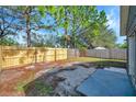 Fenced backyard with fresh sod ready for enjoyment and outdoor activities under the blue sky and sunny weather at 7459 Oxford Garden Cir, Apollo Beach, FL 33572