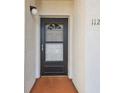 Condo entryway featuring a black apartment door and visible unit number at 7623 Radcliffe Cir # 112A, Port Richey, FL 34668