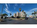 Well-maintained condo building boasts lush landscaping, palm trees, and convenient parking for residents and visitors at 7700 Sun Island S Dr # 608, South Pasadena, FL 33707