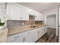 Beautiful kitchen with granite countertops, tile backsplash, and stainless steel appliances at 924 N Castle Ct, Tampa, FL 33612