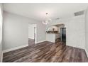 Open living room with hardwood floors, brick archway, and modern lighting at 924 N Castle Ct, Tampa, FL 33612