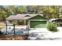 Charming single-story home featuring an attached garage, a lush lawn, and mature trees, perfect for suburban living at 9377 Preston Rd, Brooksville, FL 34601