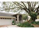 Lovely home with a grand entrance featuring arched brick columns and well-maintained landscaping at 16209 Belle Meade Blvd, Odessa, FL 33556