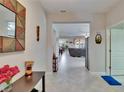 Inviting hallway with tile floors, leading to the living and dining areas, creating an open feel at 16868 Scuba Crest St, Wimauma, FL 33598