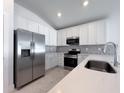Well-equipped kitchen with stainless steel refrigerator, sleek appliances and stylish fixtures at 22442 Peachland Blvd, Port Charlotte, FL 33954