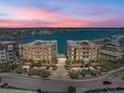 Stunning aerial view of waterfront condo buildings with a community pool and beach views at 240 108Th Ave # 102, Treasure Island, FL 33706