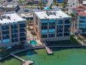 Condo buildings with a community pool and dock access to the ocean at 240 108Th Ave # 102, Treasure Island, FL 33706