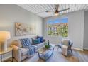 Bright living room featuring a comfortable sofa, accent chair, and large window with a view at 2402 W Azeele St # 423, Tampa, FL 33609