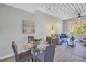 Comfortable living space featuring a dining table, sofa, and a view from the large window at 2402 W Azeele St # 423, Tampa, FL 33609