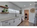 Functional kitchenette shows white subway tile, wood accents, and convenient laundry area at 315 40Th S St, St Petersburg, FL 33711