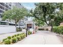 Condominium entrance with lush landscaping, security booth, and gated access for privacy at 3211 W Swann Ave # 502, Tampa, FL 33609