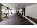 Arched covered garage with brick pavers and access to building and parking at 3211 W Swann Ave # 502, Tampa, FL 33609