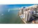 A panoramic aerial shot of the condo building, oceanfront location, and the surrounding coastal landscape at 450 S Gulfview Blvd # 605, Clearwater Beach, FL 33767