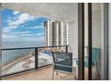 The condo's balcony features seating with unobstructed ocean views and overlooks a pool deck at 450 S Gulfview Blvd # 605, Clearwater Beach, FL 33767