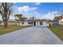 Charming home with a fresh lawn, long driveway, and eye-catching mailbox at 5220 Pine St, Seffner, FL 33584