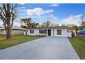 Charming home has long driveway, eye-catching wooden mailbox, and fresh lawn at 5220 Pine St, Seffner, FL 33584