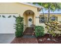 Inviting front entrance with brick pathway and arched entry, leading to a bright, cheerful home at 6041 16Th Ne Ln, St Petersburg, FL 33703