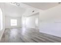 Bright and spacious living room with vaulted ceilings and modern gray flooring at 6906 N Lynn Ave, Tampa, FL 33604