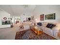 Bright living room with vaulted ceilings, fireplace, and comfortable seating area at 8003 Bardmoor Pl # 204, Seminole, FL 33777