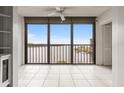 Bright enclosed lanai boasts tiled floors and panoramic water views, creating a serene indoor-outdoor living space at 8141 Aquila St # 322, Port Richey, FL 34668