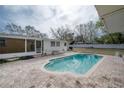 Private backyard with a sparkling in-ground pool and a spacious brick patio at 9618 N 55Th St, Temple Terrace, FL 33617