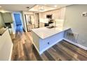 Open-concept kitchen featuring an island with a breakfast bar and stainless steel appliances at 9914 Indian Key Trl # 32, Seminole, FL 33776