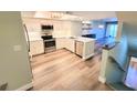 Spacious kitchen with stainless steel appliances, updated cabinets, and a large island at 9914 Indian Key Trl # 32, Seminole, FL 33776
