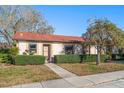 Inviting condo exterior featuring manicured hedges and a well-maintained lawn at 11511 113Th St # 25A, Largo, FL 33778