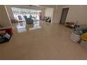 Spacious living room with tile flooring and access to the screened-in pool area at 13913 Dominica Dr, Seminole, FL 33776
