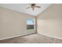 A bright bedroom featuring neutral walls, a ceiling fan, and natural light from a window at 1521 Ledgestone Dr, Brandon, FL 33511