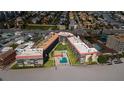 An aerial view of condos, pool, and beach with ocean access at 17580 Gulf Blvd # 302, Redington Shores, FL 33708