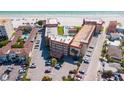 An aerial view of the condominium complex, nestled along a pristine beach with a pool at 17580 Gulf Blvd # 302, Redington Shores, FL 33708