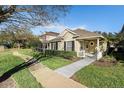 Charming home features a manicured lawn, covered entry, and a walkway, offering a warm welcome at 17916 Havenview Ln, Lutz, FL 33558