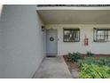 Inviting condo entrance with a welcoming wreath and lush landscaping at 1905 Oyster Catcher Ln # 911, Clearwater, FL 33762