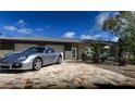Charming single story home with a brick driveway and a modern gray color scheme at 2215 River Ridge Dr, Sarasota, FL 34239