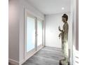 Bright hallway featuring wood-look floors, fresh paint, and a Buddha statue at 2215 River Ridge Dr, Sarasota, FL 34239
