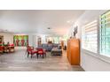 Open concept living room featuring wood-look floors, a large grey sectional, and modern art at 2215 River Ridge Dr, Sarasota, FL 34239