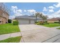 Spacious driveway leading to a well-maintained home with a three-car garage at 23331 Abercorn Ln, Land O Lakes, FL 34639