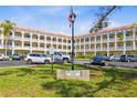 Well-maintained condo complex with manicured lawn and American flag in front at 2404 Florentine Way # 40, Clearwater, FL 33763