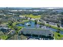 Beautiful aerial view of a lakeside apartment building featuring palm trees and meticulously maintained landscaping at 3001 58Th S Ave # 312, St Petersburg, FL 33712