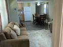 Inviting living room with plush carpeting, comfortable seating, and natural light at 36416 Cordova Cir, Zephyrhills, FL 33541