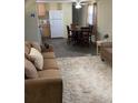 Inviting living room with plush carpeting, comfortable seating, and natural light at 36416 Cordova Cir, Zephyrhills, FL 33541