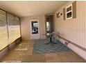Enclosed porch with tile flooring, blue rug, and windows offering natural light at 36416 Cordova Cir, Zephyrhills, FL 33541