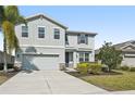 Inviting two-story home with a spacious driveway and lush green lawn at 4515 Bent Tree Blvd, Sarasota, FL 34241