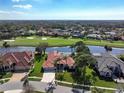 Stunning aerial view of a home on a golf course with a lake view at 4906 Turtle Creek Trl, Oldsmar, FL 34677