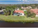 Waterfront home with a screened in pool and expansive backyard with lush landscaping at 4906 Turtle Creek Trl, Oldsmar, FL 34677