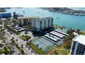 Condo building with community amenities like pool and tennis courts offer a luxurious waterfront lifestyle at 660 Island Way # 202, Clearwater Beach, FL 33767